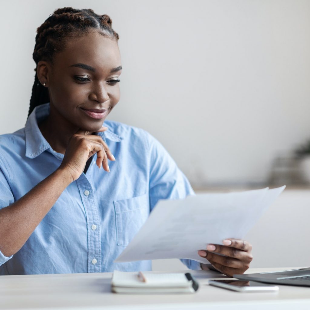 Ambitious Black Female Entrepreneur Working With Business Documentation In Office